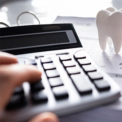 A patient calculating the cost of root canal treatment