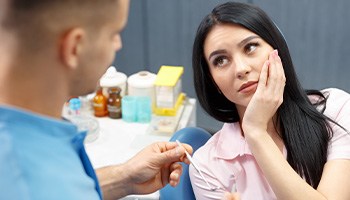 A woman with a toothache consulting her dentist