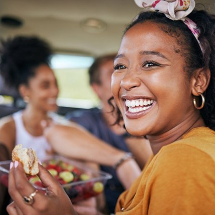 Patient in Catonsville smiling with friends after direct bonding