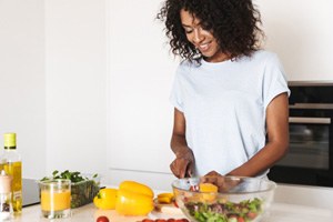 Woman preparing healthy meal in kitchen at home